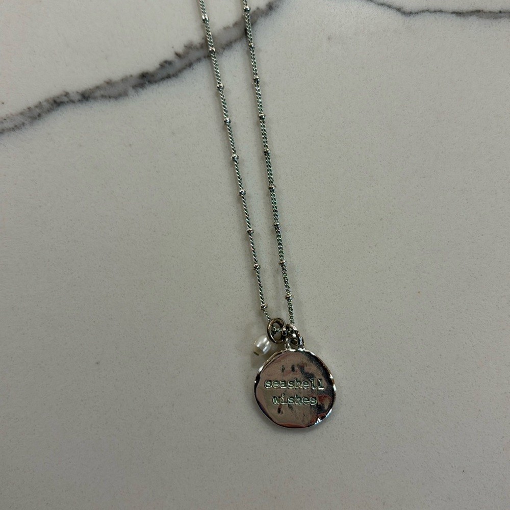 Silver necklace with extended closure.